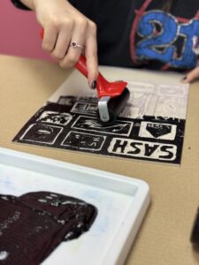 Eden lino printing the SASH charity chocolate bar at Choc Affair in York